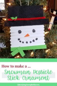 pinterest image of snowman popsicle stick ornament with text overlay